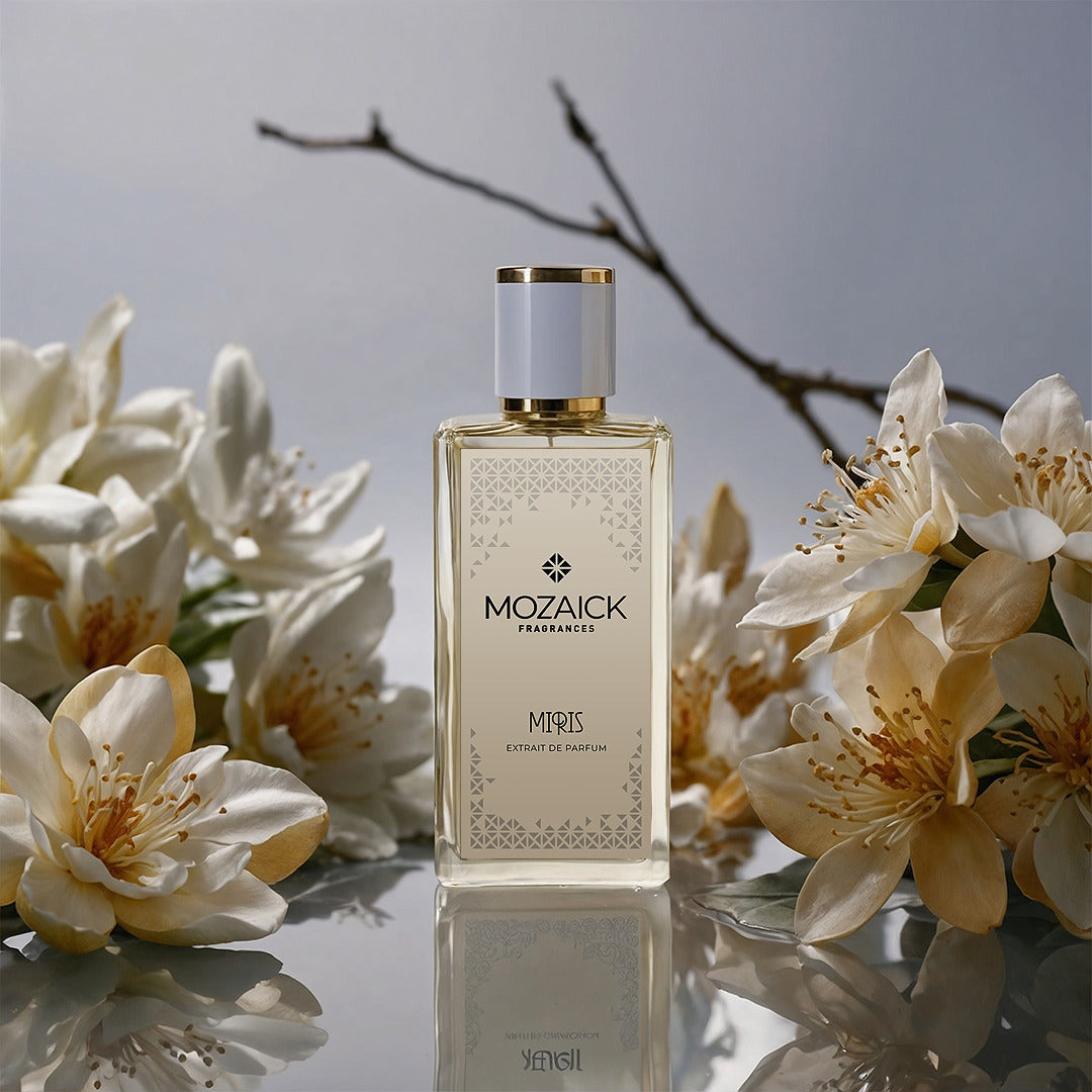 MIRIS Extrait de Parfum 50 ml von MOZAICK – Flakon mit weißen Blüten und Zweig vor grauem Hintergrund